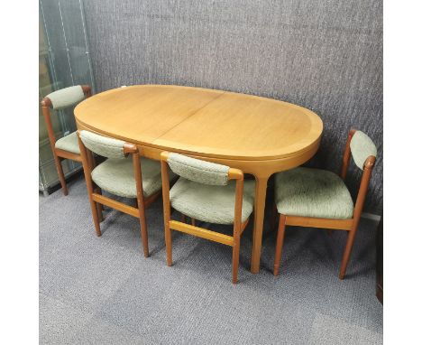 A vintage light oak extending oval dining table, 152 x 99cm, together with a set of four teak dining chairs.