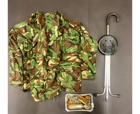 A military camoflage uniform with various military related used ammunition.