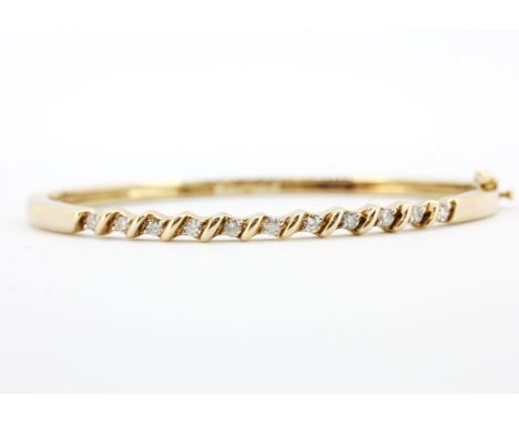 A hallmarked 9ct yellow gold bangle set with brilliant cut diamonds, approx. 0.50ct total, colour H, clarity SI, 6.5cm x 5.5c