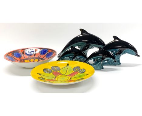 Two Poole pottery bowls (red one A/F) Dia. 27cm, with four Poole dolphins.