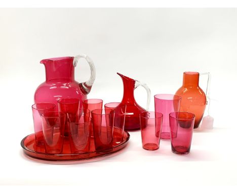 A large 19th century cranberry glass water jug, H. 21cm, together with further cranberry and ruby glass items.