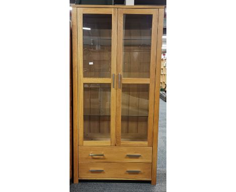 A modern light oak display cabinet with glass shelves, 190 x 92 x 44cm.