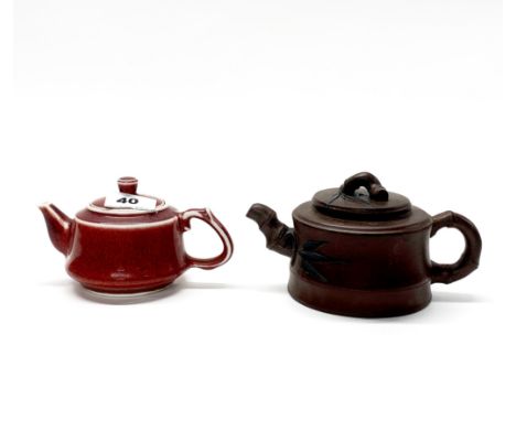 A Chinese Yi Xing terracotta teapot, H. 9cm, spout to handle 14cm, together with a sang de beouf terracotta teapot.