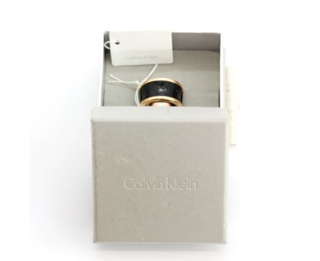 A boxed Calvin Klein yellow metal leather set ring, (M).
