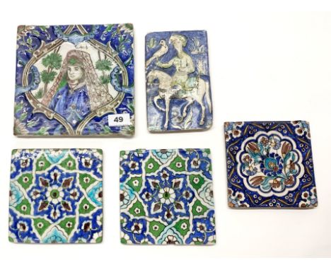 A group of five early Persian hand painted ceramic tiles, largest 21 x 21cm.