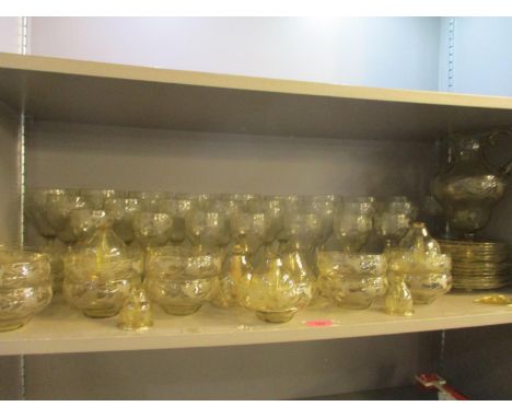 A suite of Italian light amber glassware with reclining engraving 