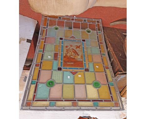 A large Victorian stained glass panel with decorative bird painted roundels