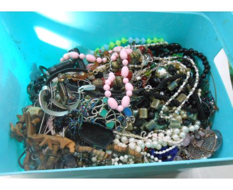 A light blue plastic crate containing a large collection of assorted costume jewellery