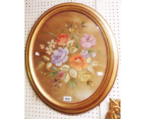 A gilt oval framed floral study embroidery panel