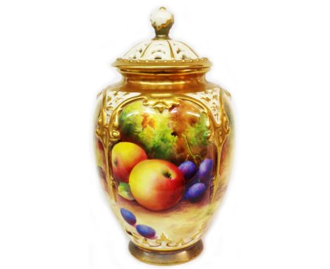A Royal Worcester porcelain lidded jar with reticulated lid and moulded strapwork with hand painted fruit decoration depictin