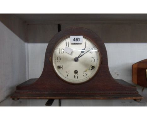 A vintage oak cased Napoleon hat mantle clock retailed by Bravington's Ltd., with eight day chiming movement