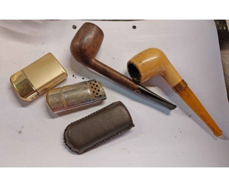 A vintage Britannia briar pipe, a Goede-Waagen example with reconstituted amber stem and three vintage lighters