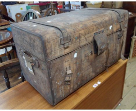A 77cm late 19th Century tooled leather bound travelling trunk with pull-down compartment to inside of lid bearing paper labe