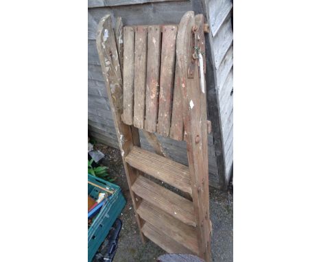 An old wooden stepladder with metal bracket fittings - for display purposes only