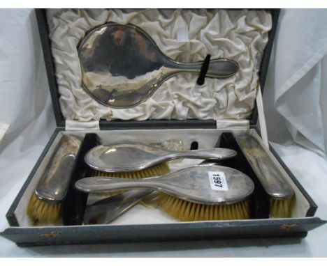 A cased silver mounted hand mirror and brush set, retailed by Waring and Gillow (comb missing), also silver handled button ho