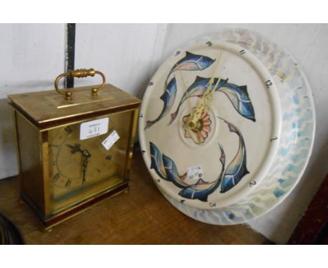 A decorative ceramic wall timepiece with stylised piscatorial decoration and battery movement - sold with a battery carriage 