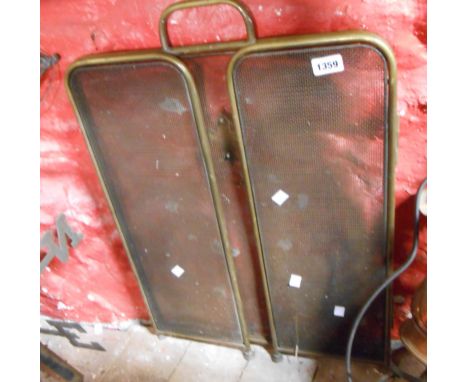 An old brass and steel mesh fireguard with brass fleur de lis decoration