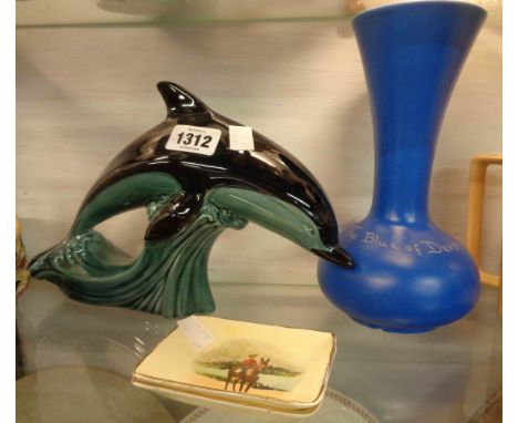 A large Poole Pottery dolphin figurine, a Devonmoor blue glazed mottoware vase and two Bovey Pottery pin souvenir dishes for 