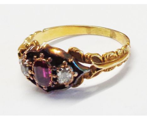 An antique unmarked yellow metal ring, set with central oval ruby and flanking small old cut diamonds - size R - later box