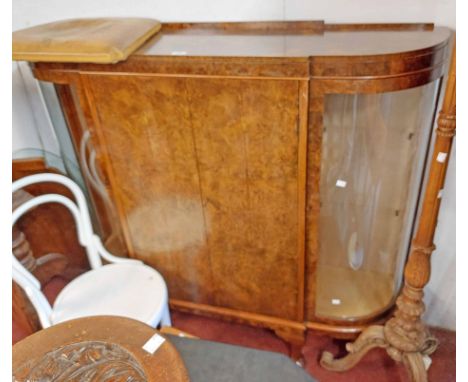 A 1.37m vintage figured walnut veneered cabinet with central door and flanking glass display shelves enclosed by curved glaze