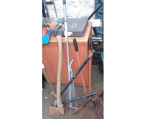 A small selection of garden and other tools including axe, sledgehammer, rake, etc.