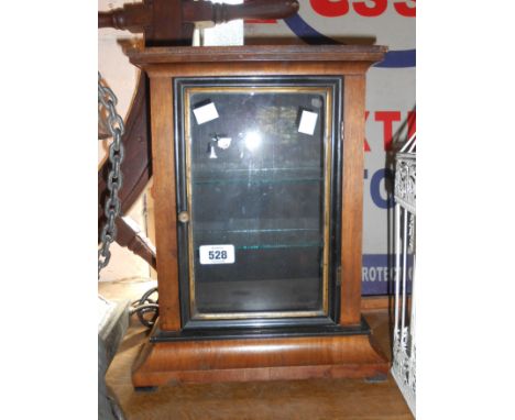 A two shelf display cabinet fashioned from an old mantle clock case