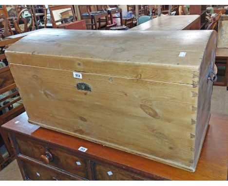 An 83cm Victorian pine dome-top travelling trunk with flanking drop handles, set on moulded rails