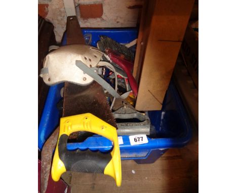A crate containing a quantity of assorted tools including saws, crowbar, etc.