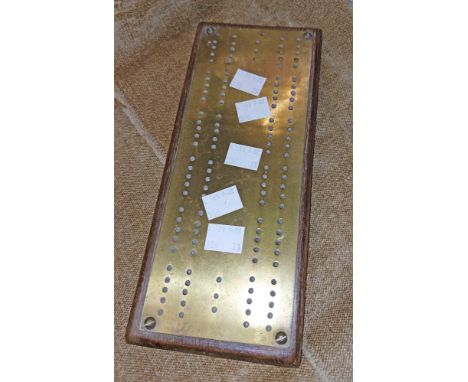 An old brass and wood cribbage board
