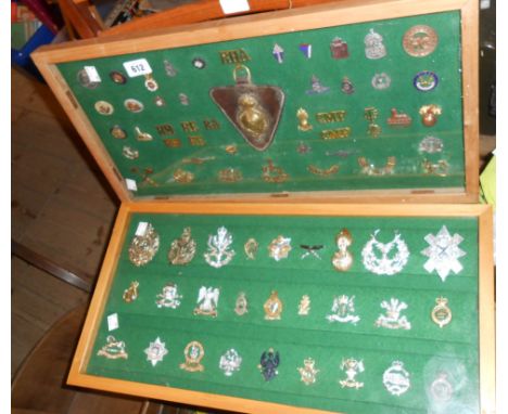 Two wooden display cases containing a quantity of military cap and pin badges including Royal Highland Fusileers, Kings Own S