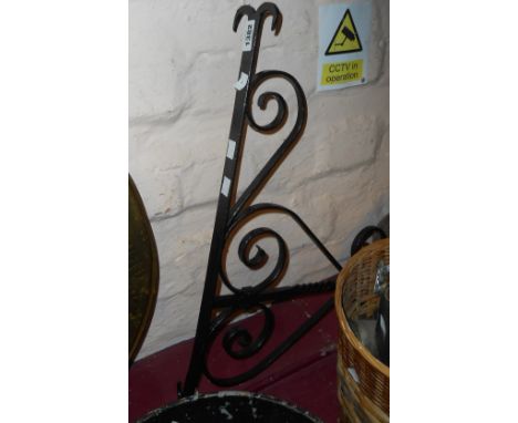 A large wrought iron sign bracket with black painted finish