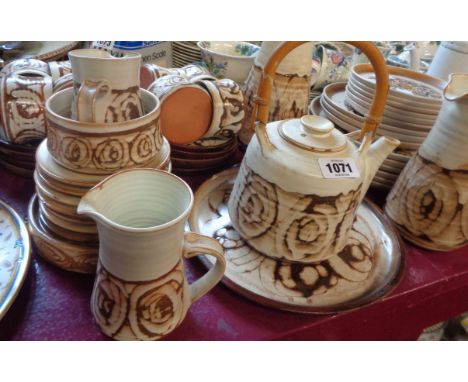 A large quantity of studio pottery teaware comprising coffee pot, teapot, milk jugs, cream and sugar, plates, bowl and cups a