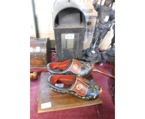 An old japanned metal glazed lantern - sold with a pair of painted clogs and a tooled leather stationery folio decorated in t