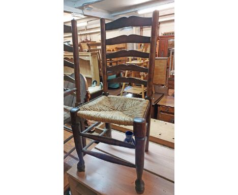 A set of six stained oak framed Lancashire ladder back dining chairs with woven rush seats, set on typical turned front suppo