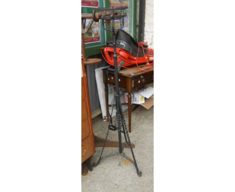 A late Victorian wrought iron telescopic oil lamp stand with later black painted finish