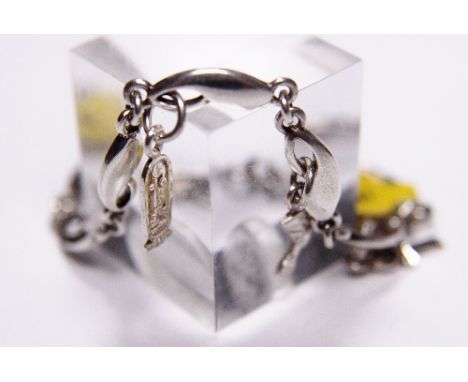SILVER CHARM BRACELET. Sterling silver bracelet with three Egyptian charms