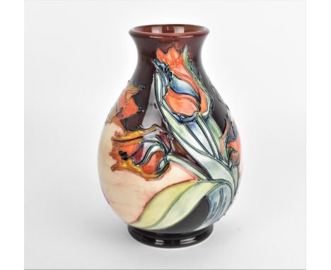 A Moorcroft pottery vase designed by Sally Tuffin, in the 'Red Tulip' pattern, of baluster form with tube-lined decoration, t