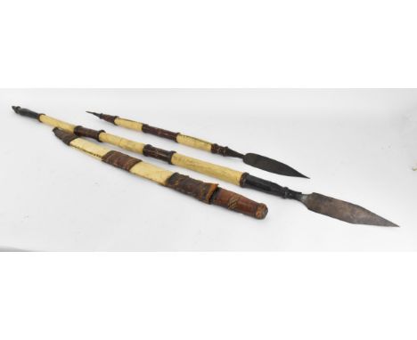 African tribal weapons comprising hide bound hunting spear and smaller example, sword with similar hide bound sheath and a da