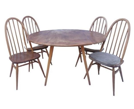 A light elm drop leaf dining table, possibly by Ercol, together with a set of four Windsor dining chairs, stamped B.S 1960 to