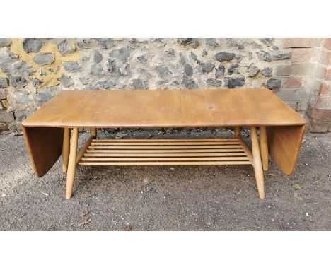 An Ercol style blonde elm and beech drop-leaf Windsor coffee table, no visible label, total width with sides up 161 cm wide x