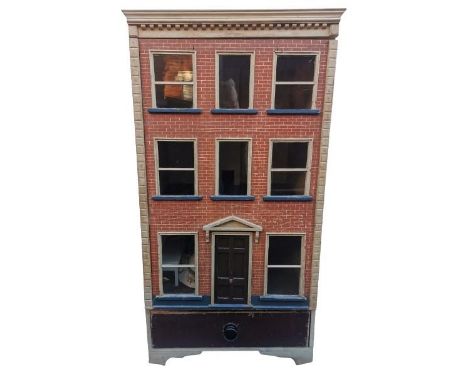 A late 19th/early 20th century doll's house, modelled as a townhouse with red brick and white dentil cornice, opening to the 