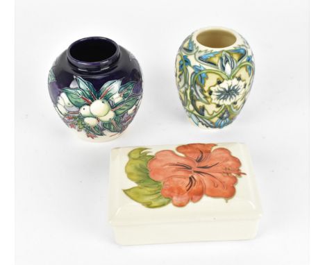 A small collection of Moorcroft pottery, to include two vases and a lidded box, one vase by Nicola Slaney in the 'Snow berry'