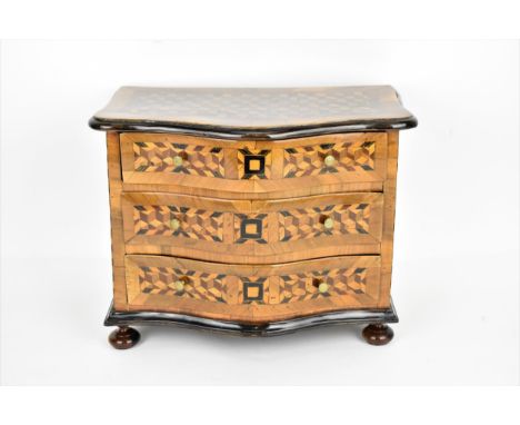 An 18th century Louis XV period miniature/apprentice commode, of serpentine form with moulded border and cube parquetry, inla