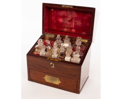 An apothecary's mahogany cabinet, 19th Century, with inlaid brass handle to the hinged cover, enclosing an interior of fitted