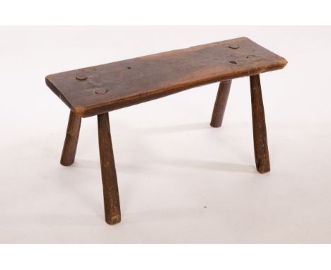 A rectangular rustic elm stool on splay supports, 79cm wide, top 26cm deep, 40cm high CONDITION REPORT: 40cm high, top 26cm d