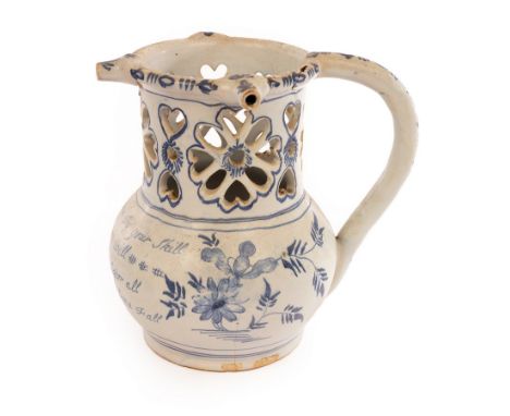 An English Delftware puzzle jug inscribed with a poem, 18cm high/see illustration CONDITION REPORT: There is a small chip to 