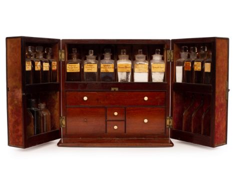 An apothecary's mahogany cabinet, 19th Century, enclosed by a pair of doors, the interior fitted bottles throughout, fitted f