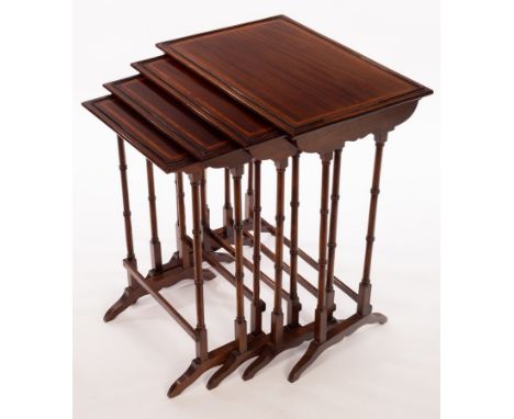 A nest of four mahogany tables banded in satinwood, on twin spindle turned end supports, the largest, 56cm wide CONDITION REP