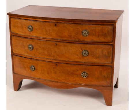 A Regency mahogany bowfront chest of three long graduated drawers, with replacement brass ring handles, on bracket feet, 102c