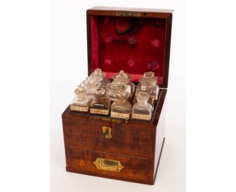 An apothecary's mahogany cabinet, 19th Century, fitted glass bottles and covers, with drawer beneath fitted scales, mixing bo